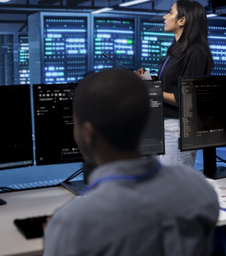 Manager in server hub using computer to find firewall misconfigurations affecting rackmounts performance. Supervisor checking systems bottlenecks leading to sluggish data transfer rates