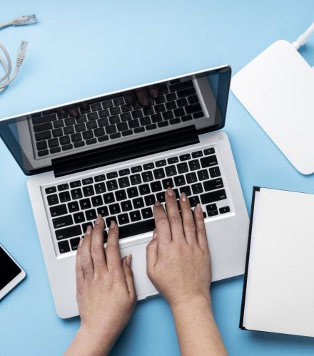 top-view-wi-fi-router-with-hands-using-laptop-smartphone